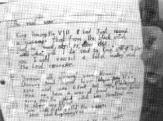 Photo: A student holds up a draft of an assignment